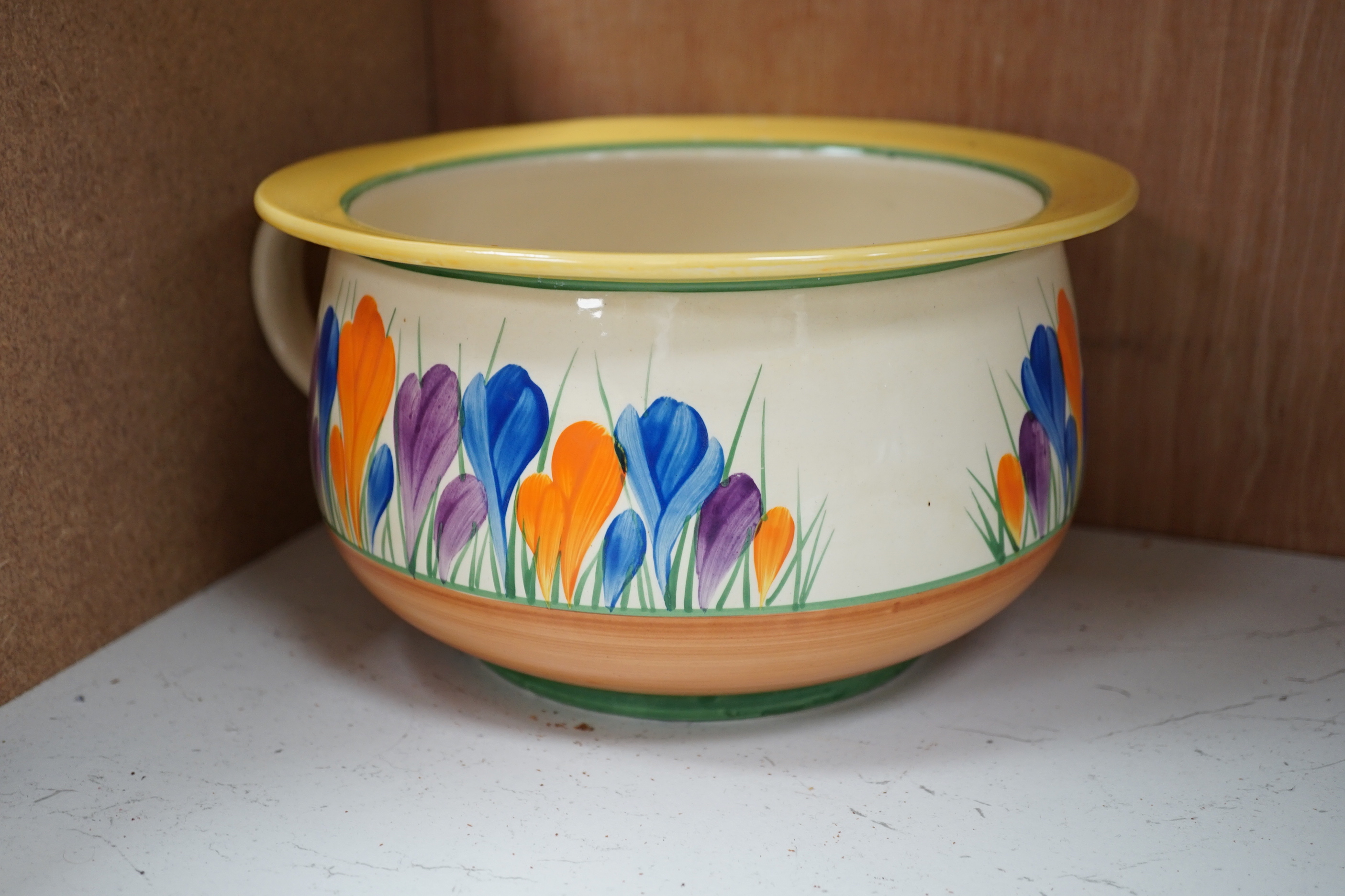 A Clarice Cliff Crocus pattern jug and basin, chamber pot and teapot with cover missing, basin 37cm diameter